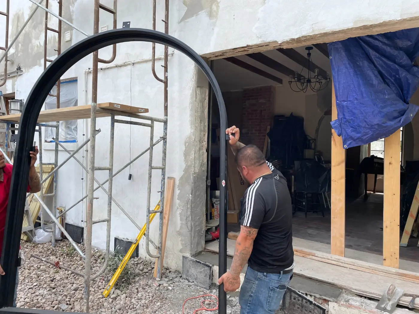 Installing the new black iron gate at the front of the property