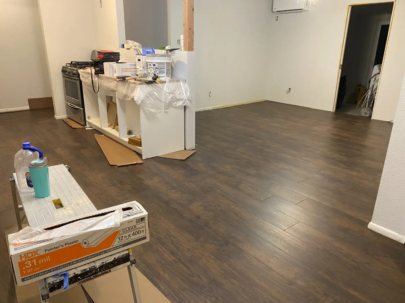 Finished room with dark brown vinyl plank flooring installed throughout