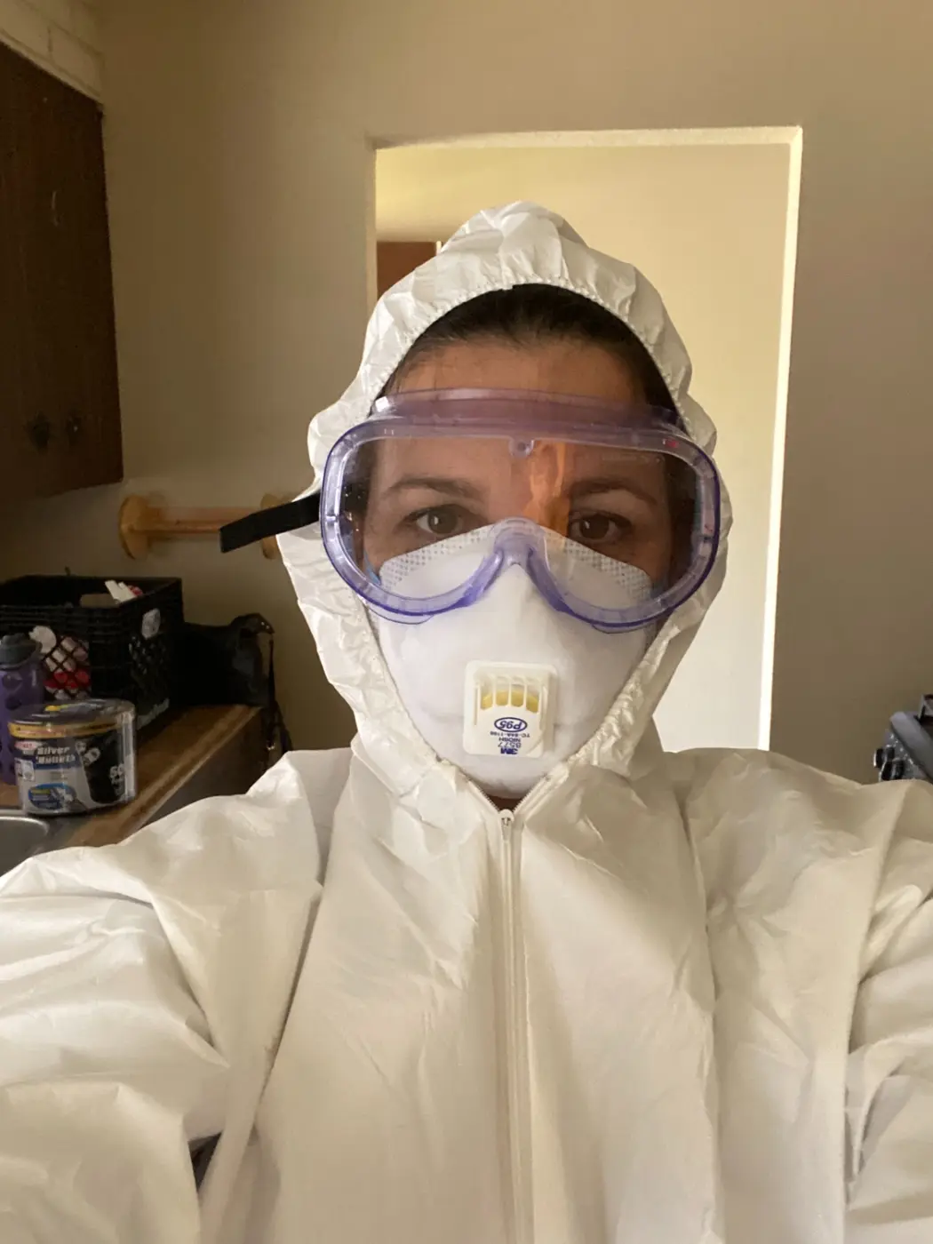 Selfie in a hazmat suit and respirator, suited up for popcorn ceiling removal
