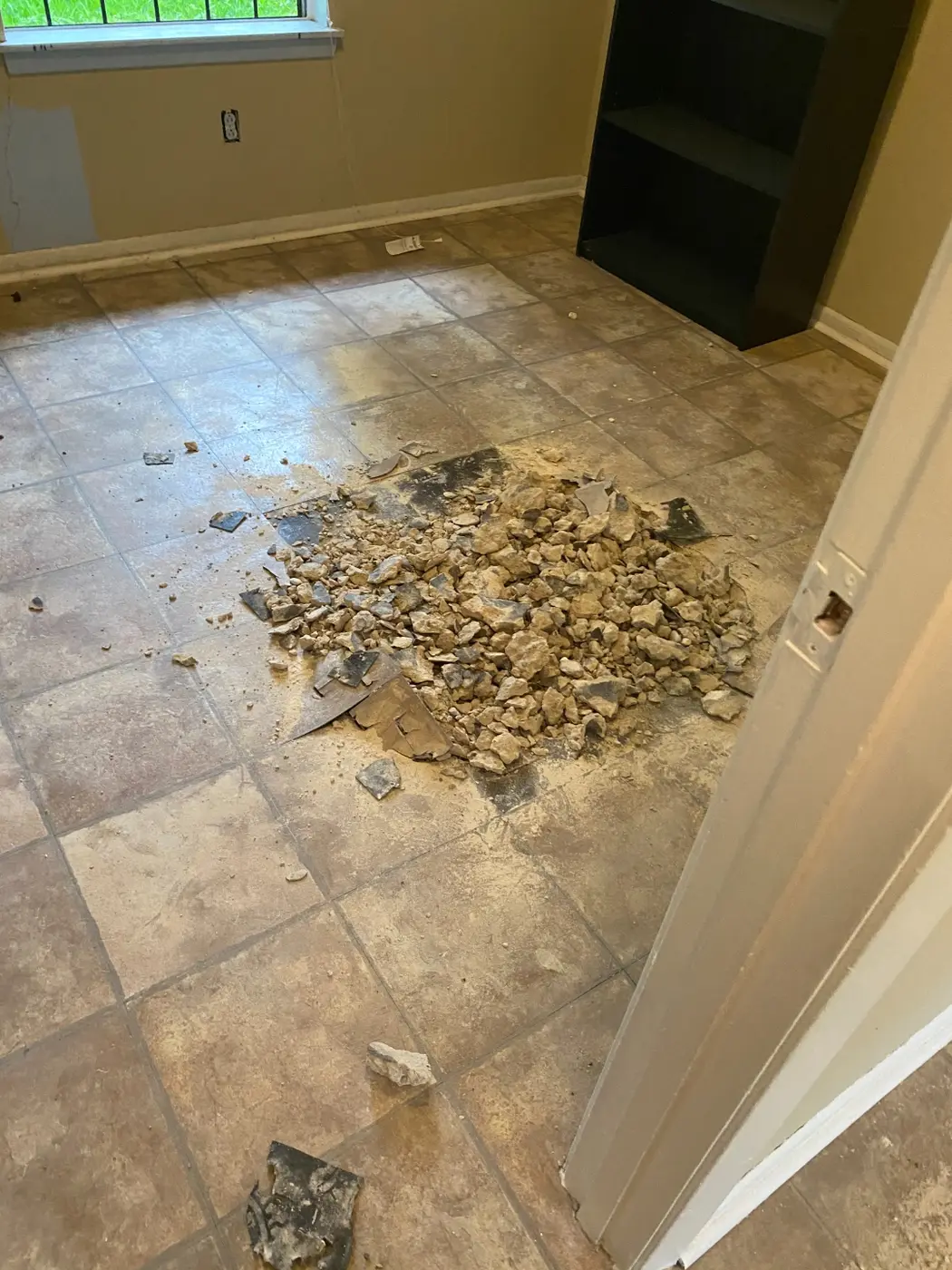 Concrete slab cut open in a room to trace the plumbing line
