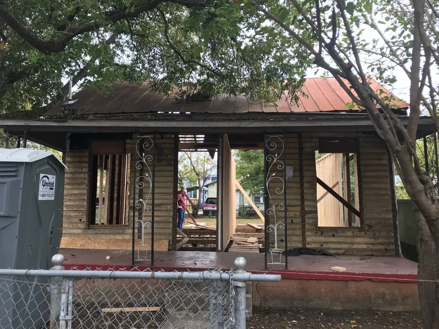 Before: the derelict house stripped to studs, framed for the new duplex layout