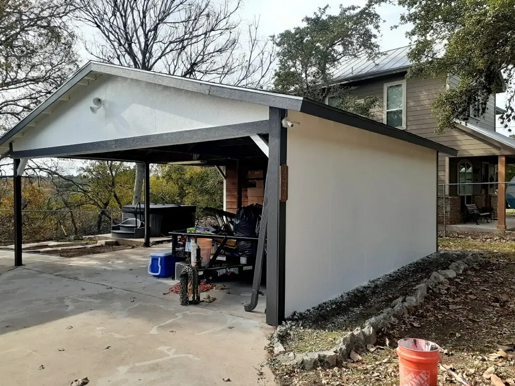 The finished carport in white and charcoal, with the new hot tub visible underneath