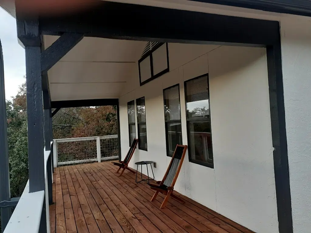 The finished deck furnished with a wood-framed lounge set