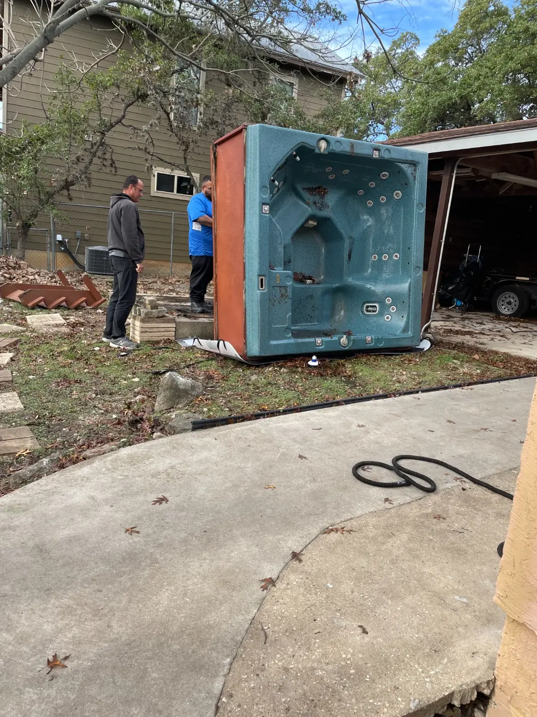Before: the old, broken hot tub being hauled out of the backyard