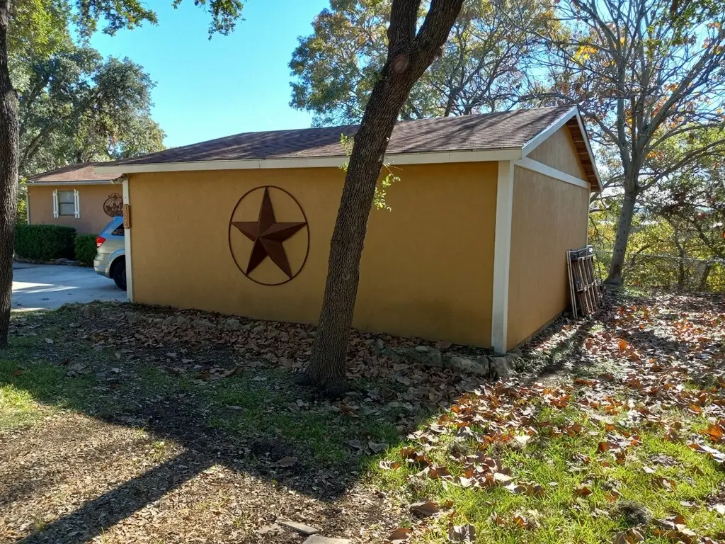 Before: the detached shed in matching tan stucco